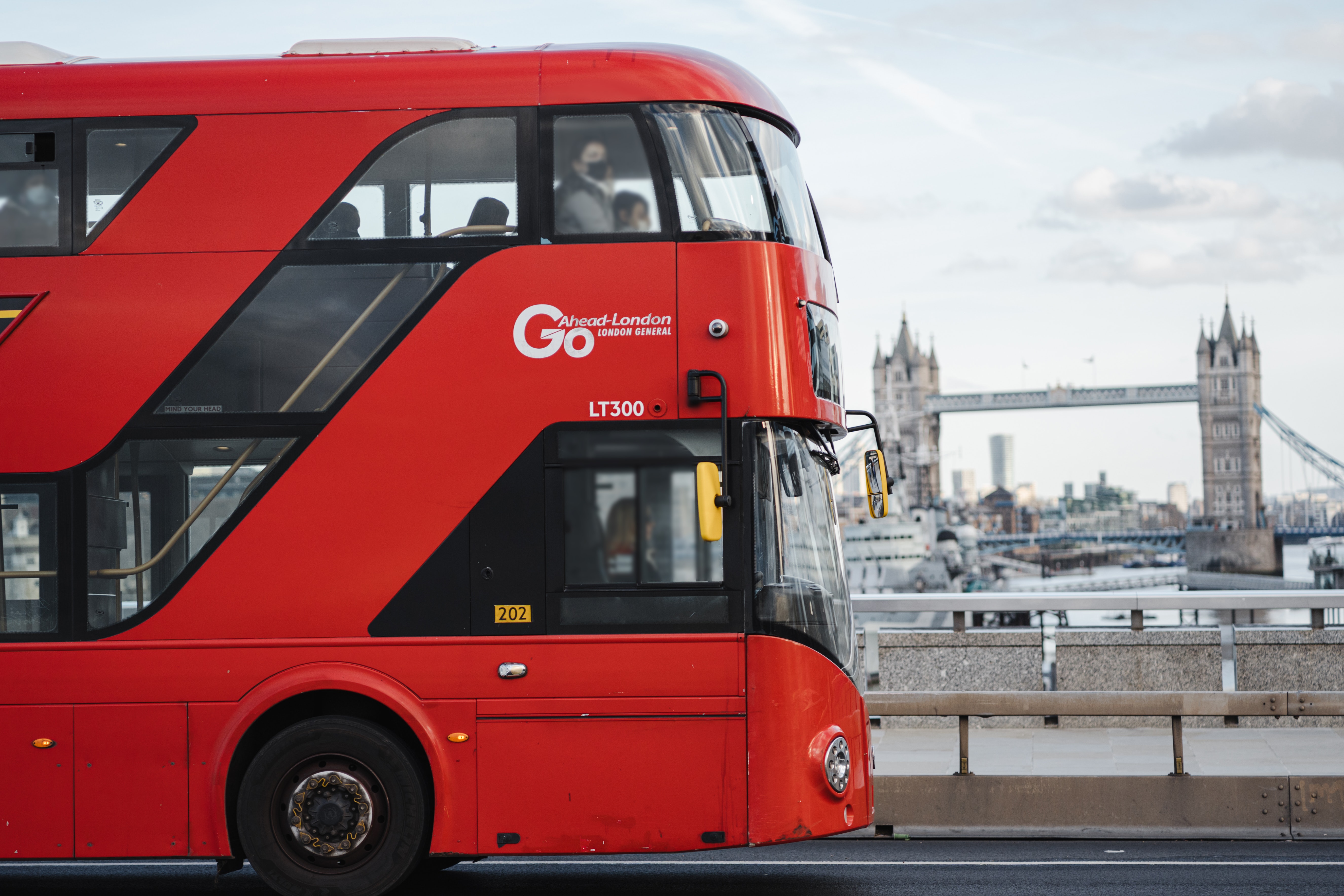 London bus with tower bridge behind 